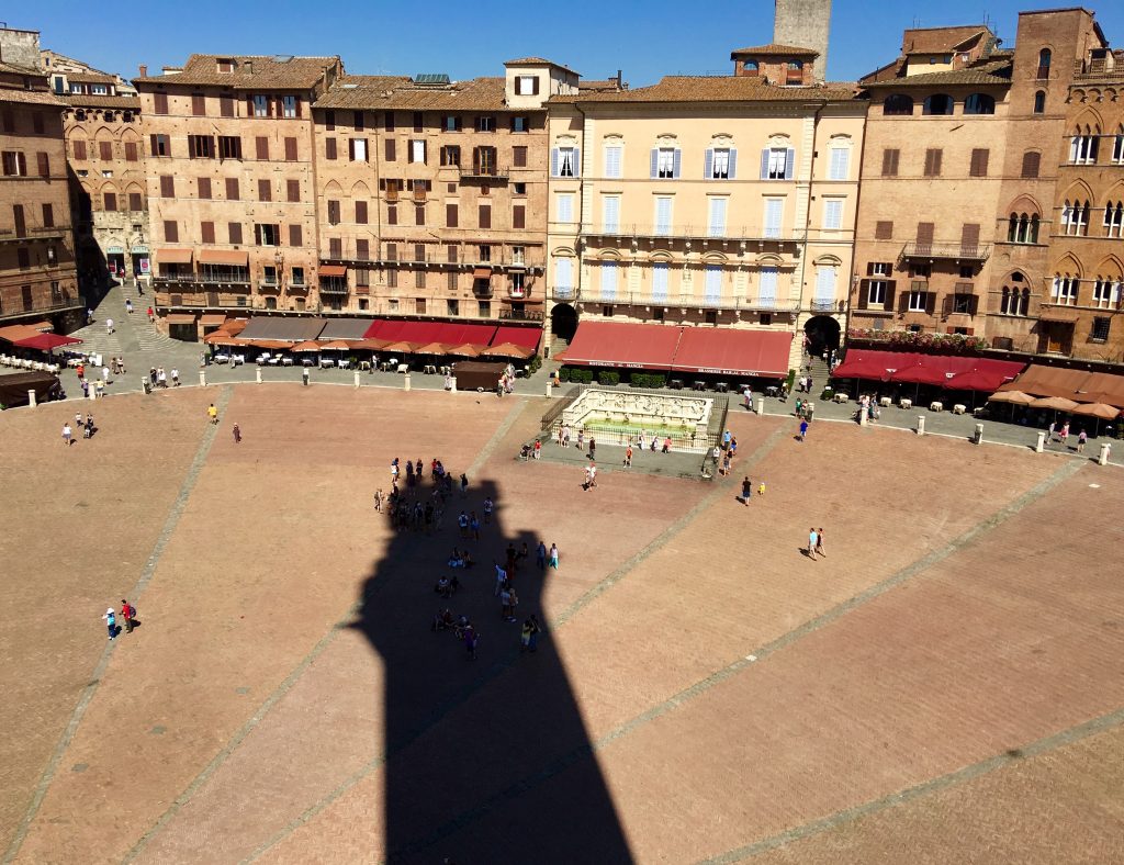The Piazza del Campo and the shadow from the Torre del Mangia. Notice where all the people are gathering? In the ombra (shade)!